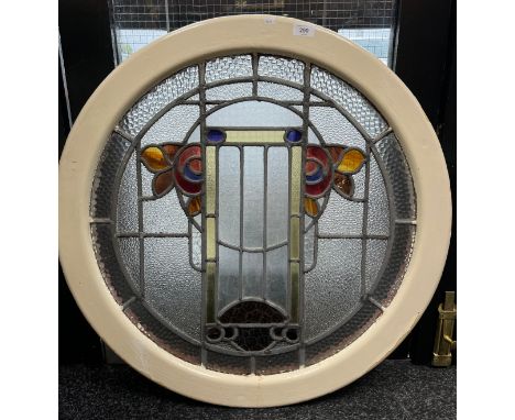 A cast iron circular surround fitted with a stained glass panel. Possibly from a ship [In an art nouveau form design] [75cm d