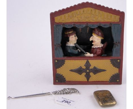 A reproduction Mr Punch moneybank,a button hook and a Punch vesta case, (3).