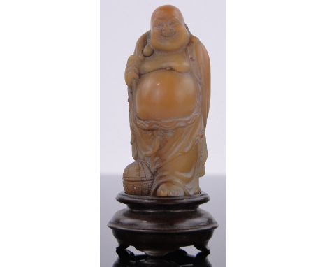 A Chinese yellow jade Buddha,carved hardwood stand, height including stand 2.5".