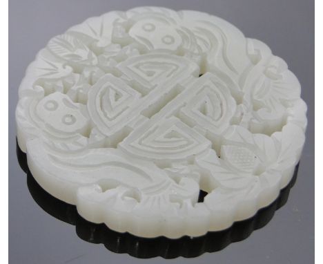 A Chinese relief carved and pierced jade disc,diameter 2.25".