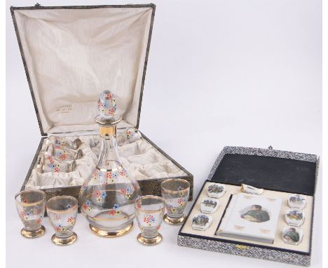 A painted and gilded glass cocktail decanter and glasses,in original fitted case together with a Limoges transfer printed Nap