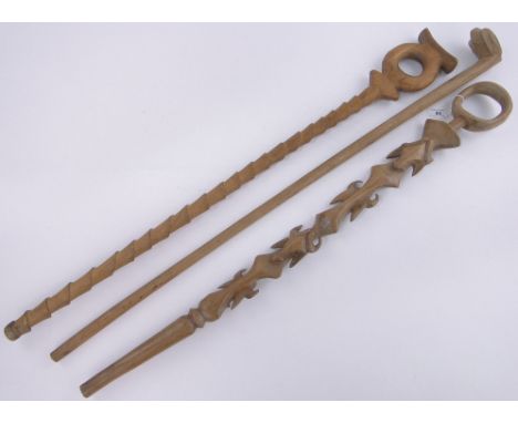 3 African carved wood sticks,including a Swazi knobkerry, a Zulu dance staff and a stick with carved bulls heads, (3).