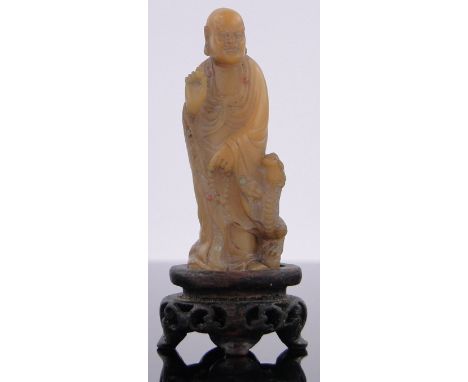 A Chinese carved yellow jade Buddha,carved hardwood stand, height including stand 2.75".