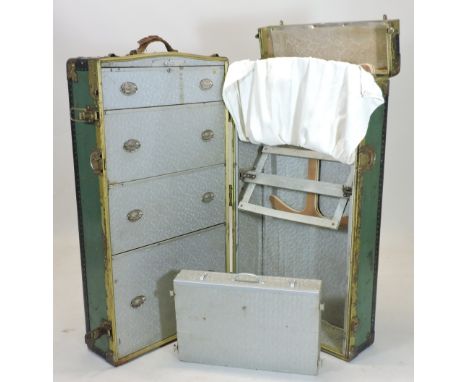 An early 20th century metal bound travelling trunk, with a fitted interior, bearing various Cunard Line travel labels, 110cm