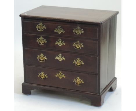 A good George III mahogany bachelor's chest, the shaped top with ebony stringing, above a brushing slide, over four graduated