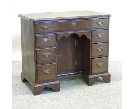 A George III oak kneehole desk, on bracket feet, 92cm