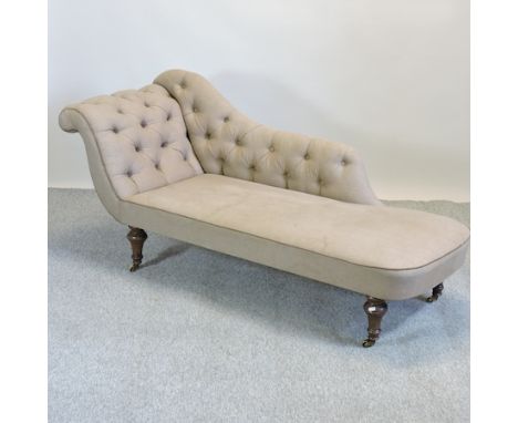 A Victorian cream upholstered button back chaise longue, on turned legs and castors, 170cm