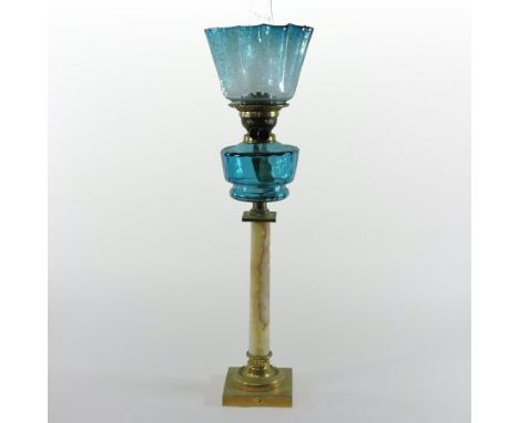 A late 19th century brass mounted onyx oil lamp, in the form of a column, with a blue glass shade, 82cm high