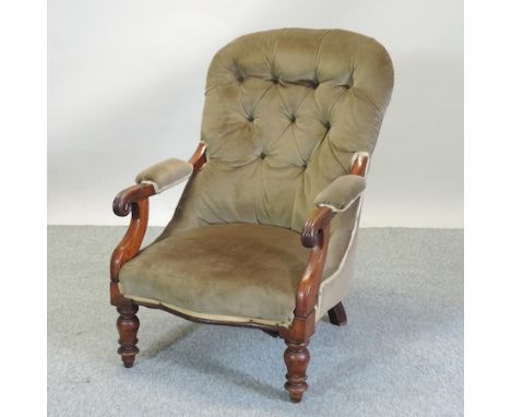 A Victorian mahogany green upholstered button back arm chair, on turned legs