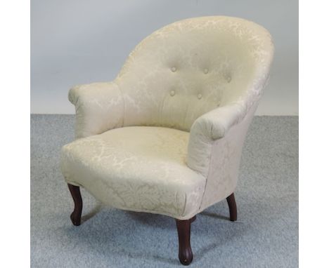A Victorian cream upholstered button back armchair