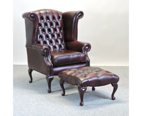A Thomas Lloyd red button upholstered wing armchair, together with a matching footstool