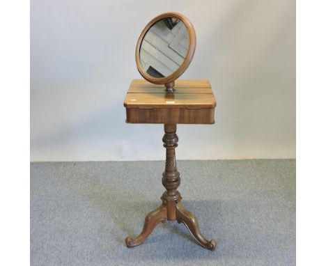 A 19th century walnut shaving stand, on a tripod base, bearing a label for T Walker and Co. Holborn, London, 42cm, with valua