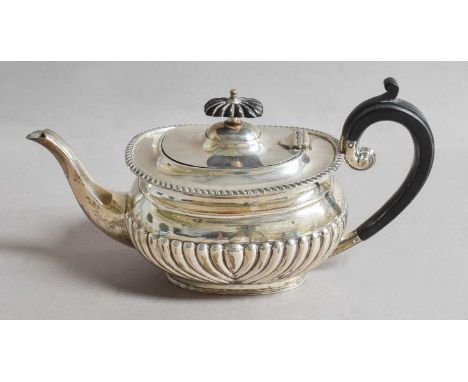 A George V Silver Teapot, by George Howson, London, 1910, oblong and with fluted lower body, with ebonised handle and finial,