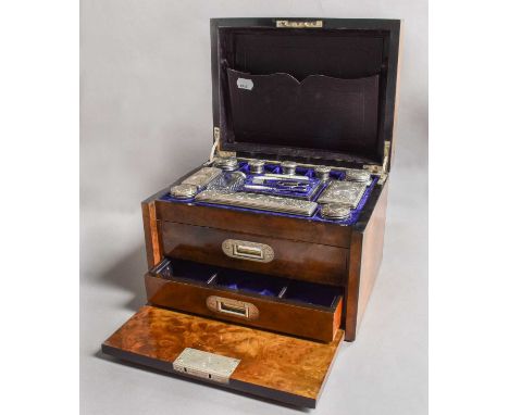 A Victorian Silver-Mounted Glass Dressing-Table Set, the silver cover engraved with foliage centring a vacant shield, compris