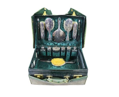 A George V Silver-Mounted Travelling Dressing-Table Service, by Walker and Hall, London or Birmingham, 1923, 1924 and 1925, w