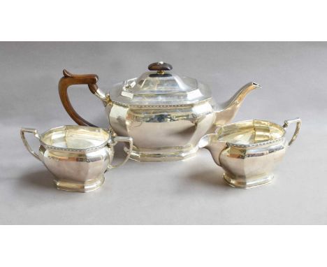 A Three-Piece Elizabeth II Silver Tea-Service, by Cooper Brothers and Sons Ltd., Sheffield, 1973, each piece elongated octago