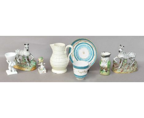 A Pair Of 19th Century Staffordshire Models Of Zebras, raised on naturalistic bases ornamented with shredded clay, together w