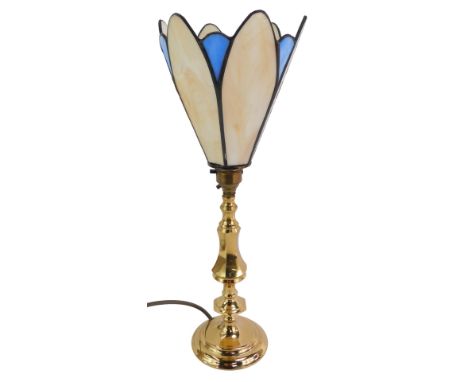 A brass table lamp, with a leaded glass shade, of petalated form, in cream and blue, 40cm high.WARNING! This lot contains unt