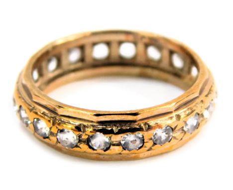 An eternity ring, set with cz stones, yellow metal stamped 9ct silver, ring size J½, 2.3g all in.