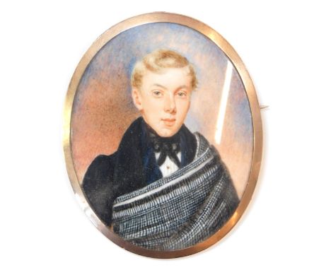 A 19thC portrait brooch, of oval design, the miniature painted oval panel depicting blonde haired gentleman in evening dress,