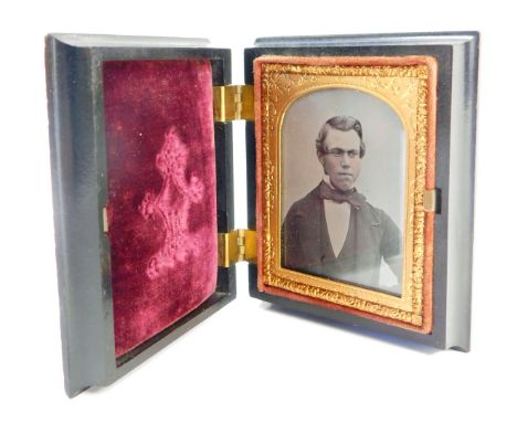 A late 19thC daguerreotype portrait, in a fitted ebonised case, with raised and applied scroll detail, with a red velvet lini