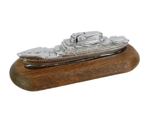 An MTC chrome novelty table lighter, modelled as a cruise liner, 16cm long, on an oak base.