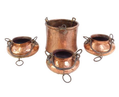 Three Eastern copper vessels, each of hammered cylindrical form with raised neck, wrought metal ring handles, 19cm high, toge