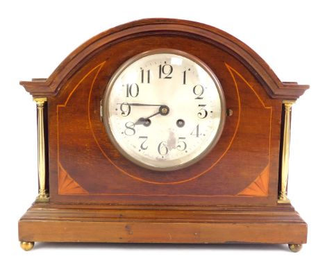 An early 20thC mahogany and inlaid mantel clock, the circular silvered dial bearing Arabic numerals, eight day, the case with