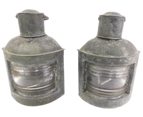 A pair of early 20thC cast metal ship's lanterns, port and starboard, with ring handles, 33cm high.