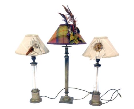 A pair of 20thC table lamps, each with a central glass column and cast metal mounts, with a tweed shade with pheasant embelli