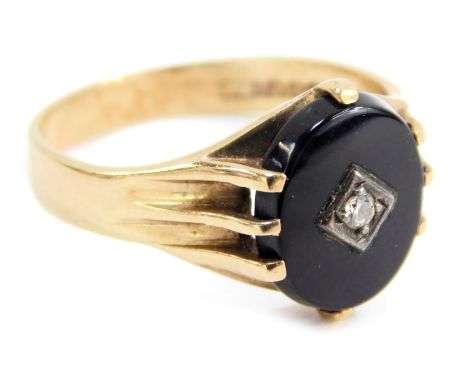 A 9ct gold dress ring, set with oval onyx and central tiny diamond, in four claw mount, with rub over border, ring size T½, 3