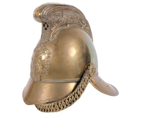 A Victorian Merryweather pattern brass fireman's helmet, dragon embossed high comb, with chin strap and liner