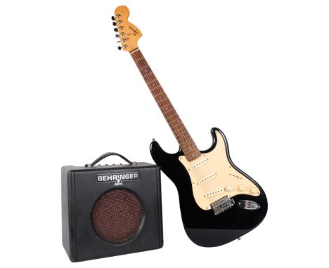 A reproduction Fender Squire Strat, 6-string electric guitar, with soft carry case, and a Behringer Practice amp