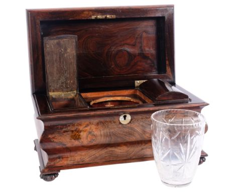 A Georgian rosewood sarcophagus tea caddy, the body with serpentine form, on cup carved feet, with box fitted interior and as