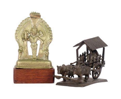 An Indian bronze deity on stand, H16cm, and an Antique bronze oxen and cart on stand (A/F), H8cm (2)