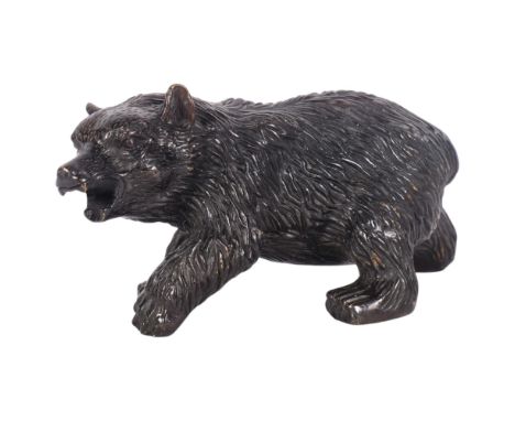 A cast-bronze study of a prowling bear with textured body, H10cm