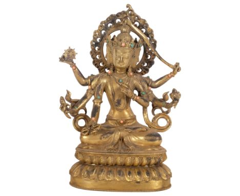 A Tibetan style bronze deity on lotus base, figure of Durga, decorated with turquoise and coral bosses, H24cm