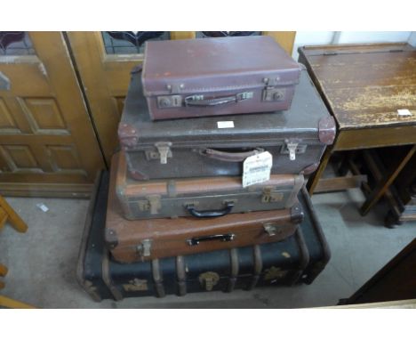 An early 20th Century steamer trunk and four vintage suitcases 