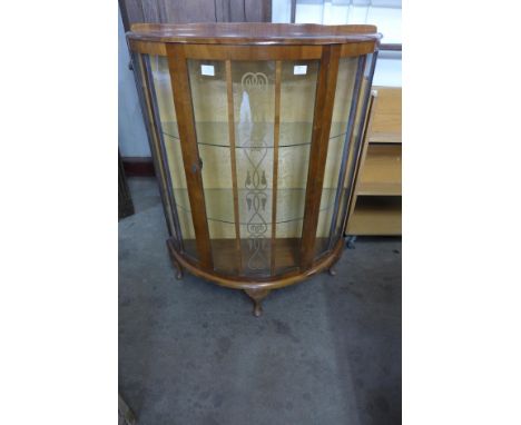 A walnut demi lune display cabinet 