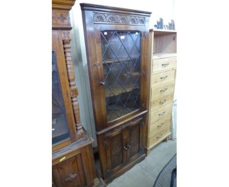 A Bevan Funnel carved oak freestanding corner cabinet 