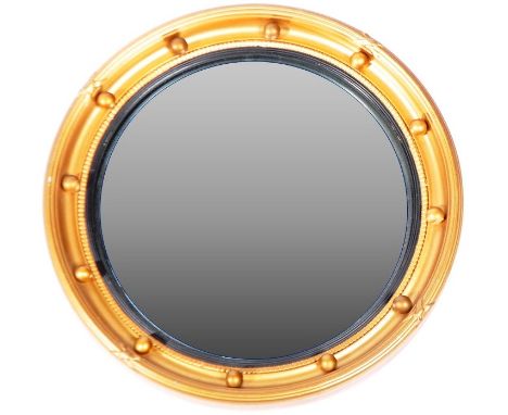 A retro vintage 20th Century Regency Revival convex fisheye wall mirror of circular form having a gilt frame with ebonised sl