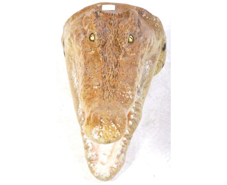 A contemporary fibreglass 1:1 scale wall mounted taxidermy style model prop of a Alligators head of typical form with open ja