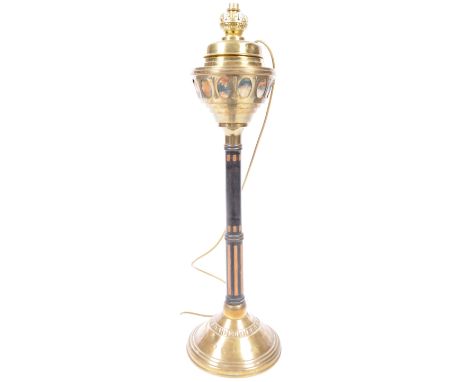 A vintage 20th Century ecclesiastical free standing brass and ebony lamp light having a brass oil light top with removable se