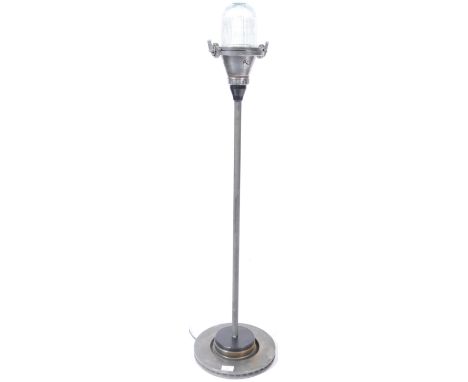 A vintage 20th Century reconditioned runway landing lamp light having a thick domed glass shade atop supported by a single po