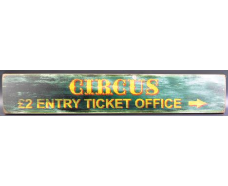 A contemporary vintage style printed wooden sign for ' Circus £2 Entry Ticket Office '. The advertising sign having a rustic 