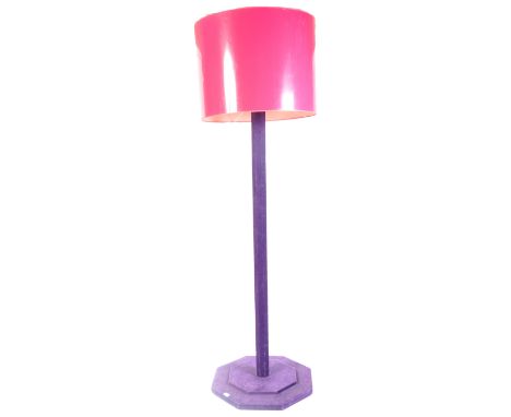 A contemporary large floor standing upright uplighter lamp light finished in a purple velvet. The standard lamp having a sing