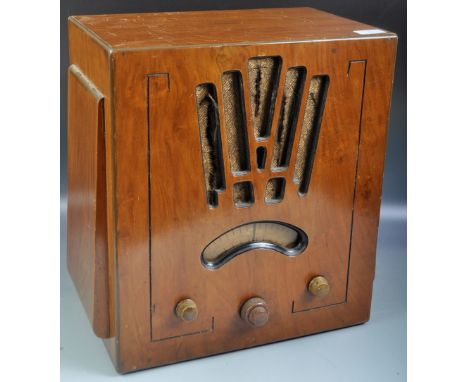 Portadyne - A vintage 20th Century English Art Deco walnut cased radio music player. The radio of upright form having decorat