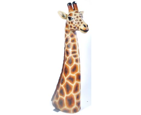 A contemporary fibreglass 1:1 scale model prop of a Giraffe's head of typical form with elongated neck and detailed head with