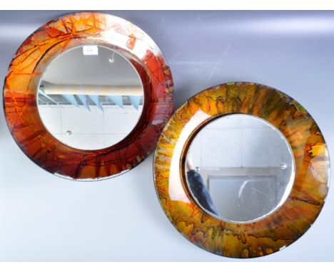 A near pair of retro vintage 1960's studio art glass wall mirrors of circular form having central circular mirrors with iride