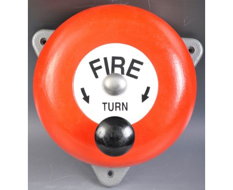 A contemporary industrial / shop fire bell / alarm of typical round form finished in a vibrant red with central plaque in whi